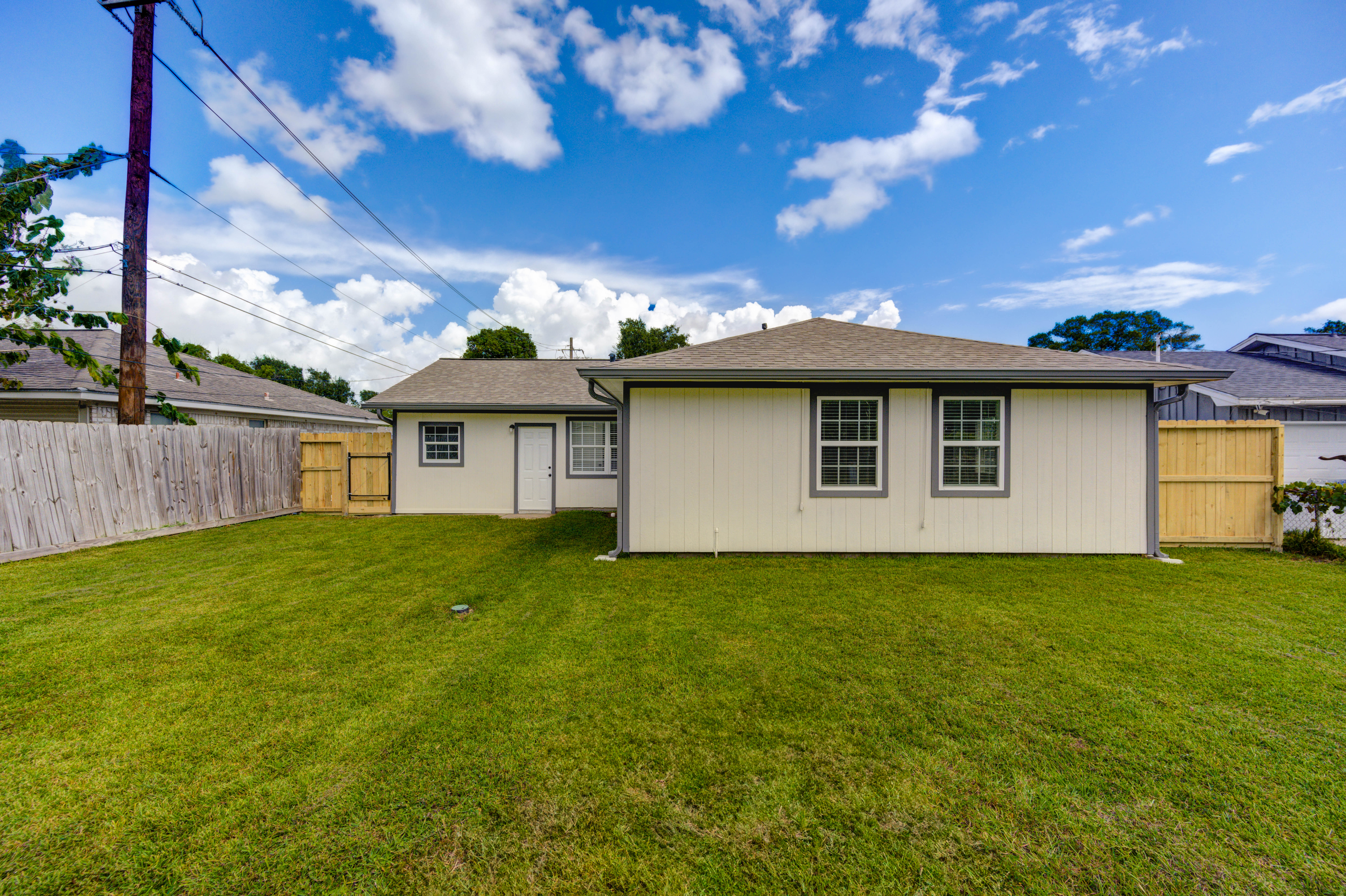 Large backyard and rear view of the home