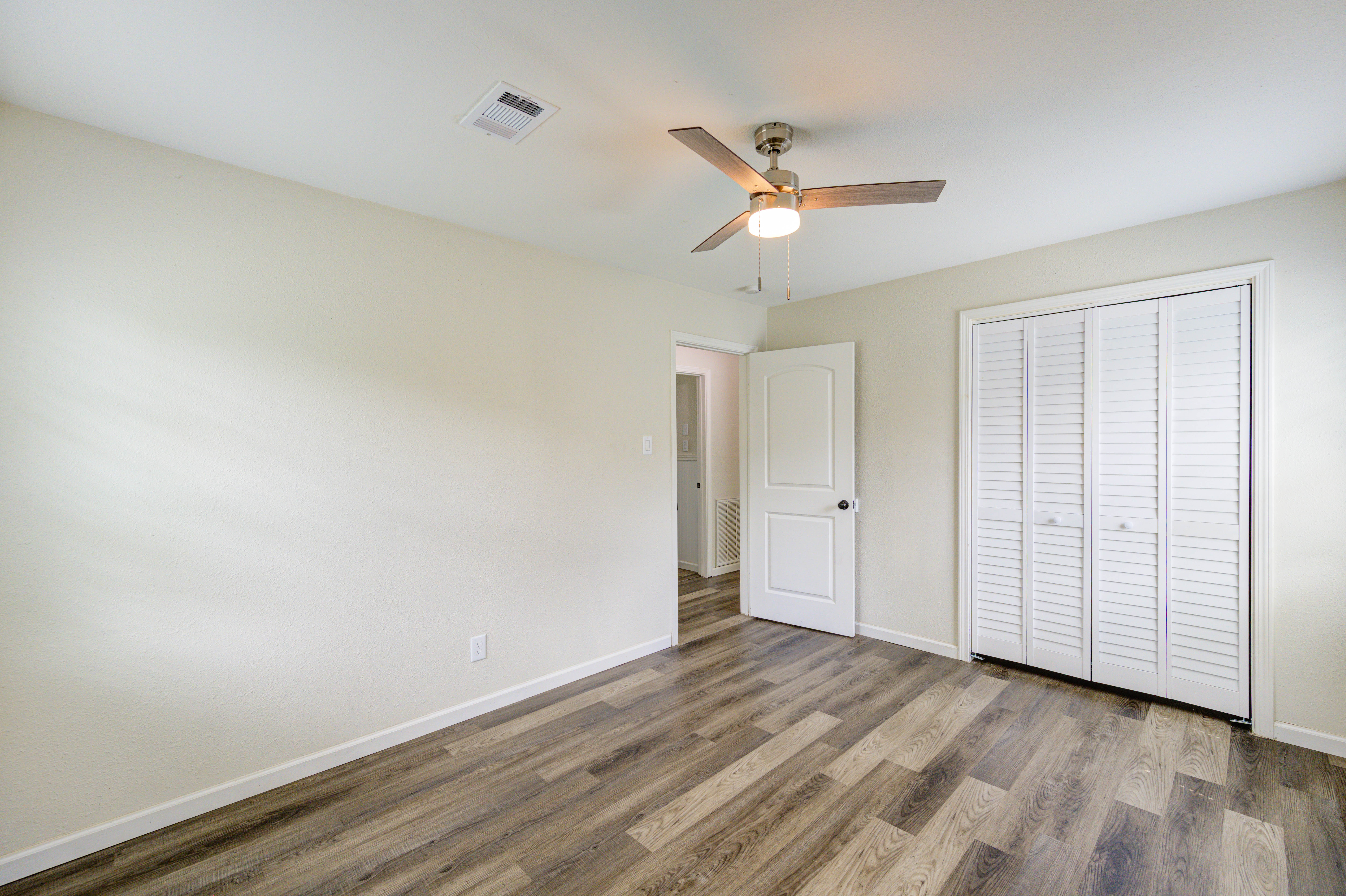 Bedroom with ceiling fan and closet