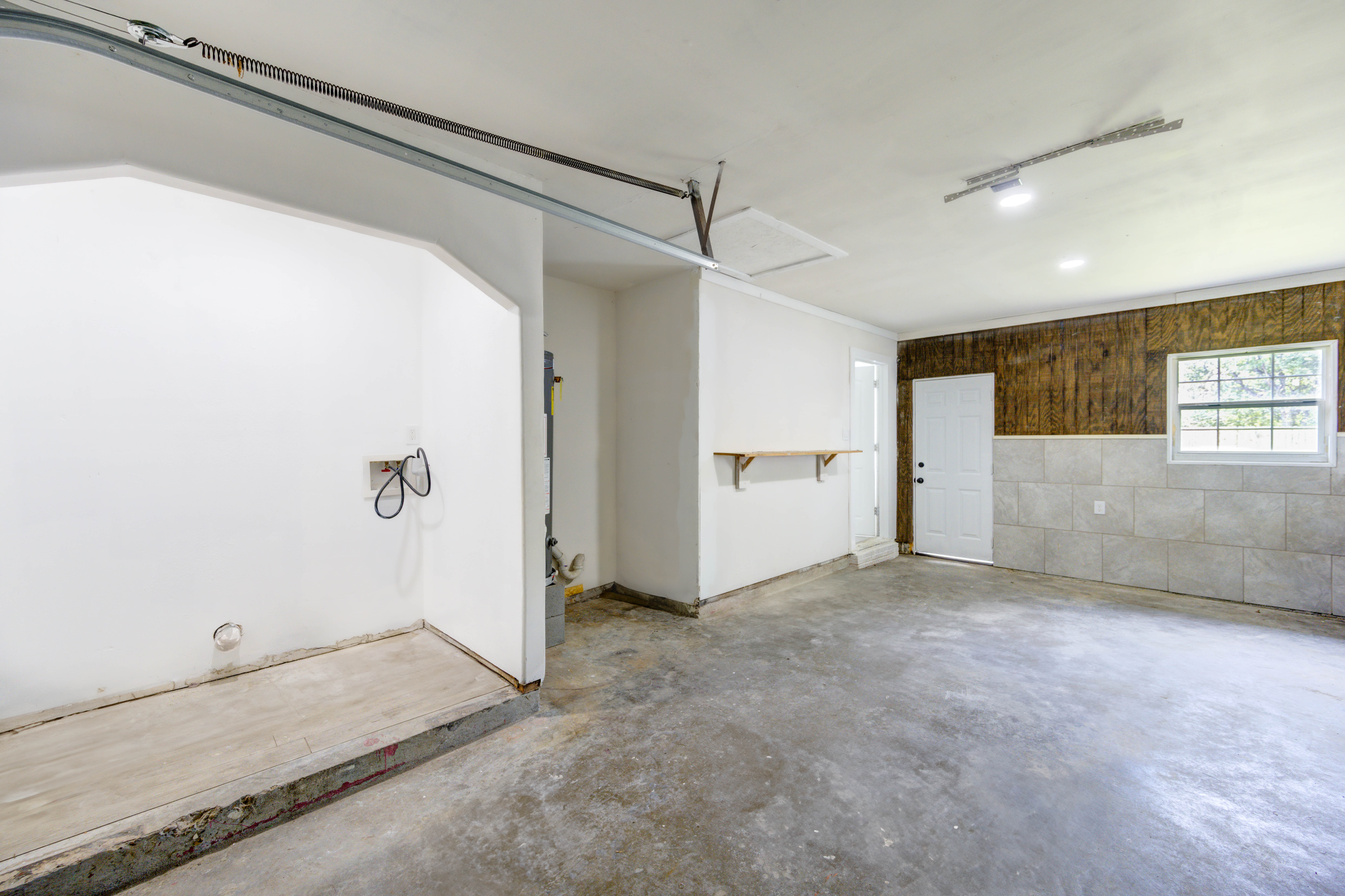 Attached garage with additional utility space