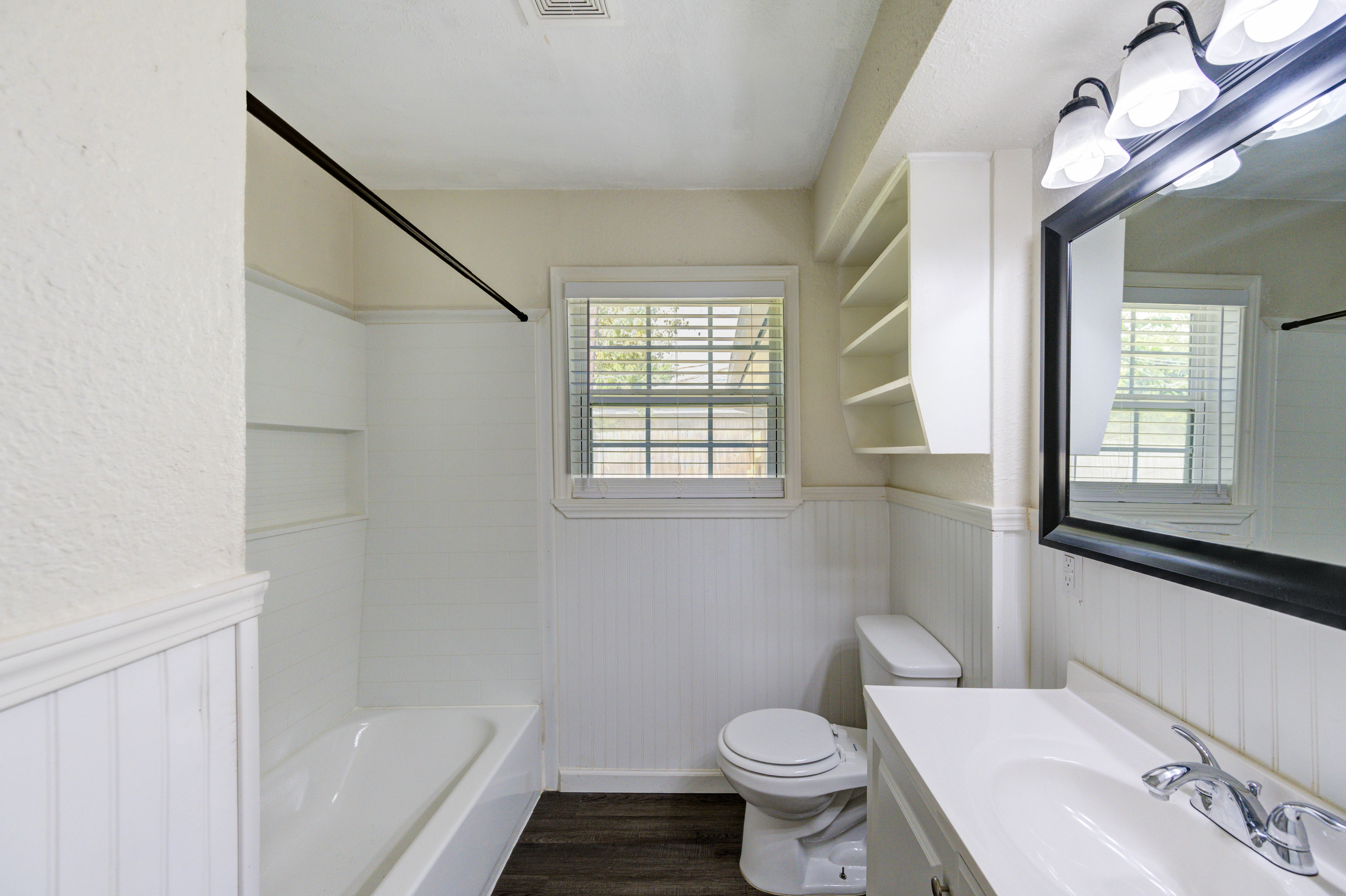 Full bath with natural light and built-in shelving